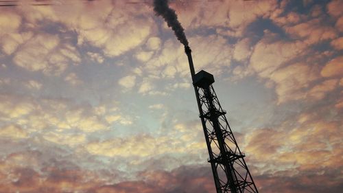 Low angle view of tower against cloudy sky