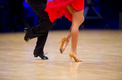 Low section of couple dancing on floor