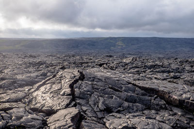 Aerial view of rocks on land against sky