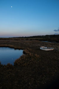 Scenic view of lake against clear sky at night