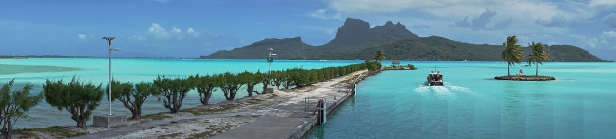 Panoramic view of sea and mountains against sky