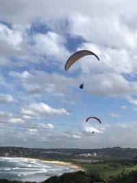 People paragliding against sky