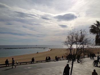 People on beach against sky