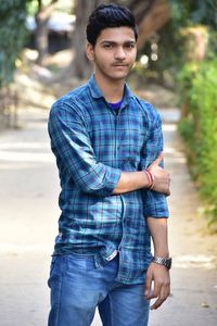 Portrait of young man standing in city