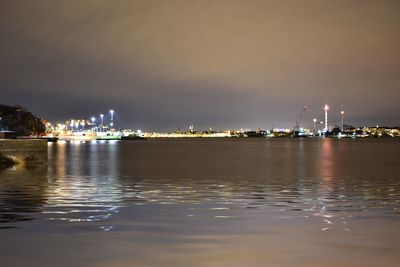 Illuminated buildings with waterfront at night