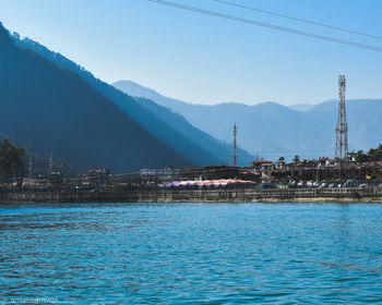 Scenic view of sea by buildings against sky