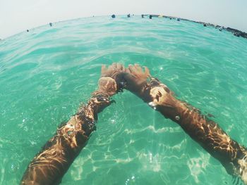 Midsection of woman swimming in sea