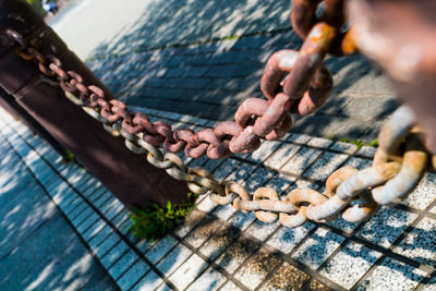 Midsection of person preparing meat on barbecue grill