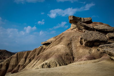 Low angle view of rock formations against sky