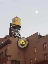 Low angle view of clock tower against sky