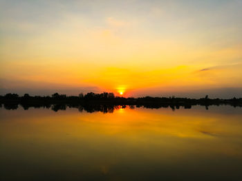 Scenic view of lake against orange sky