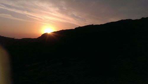 Scenic view of silhouette mountains against sky during sunset