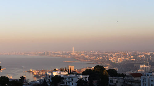 Buildings in city at sunset