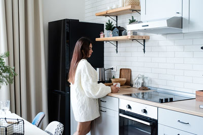 Midsection of woman preparing food at home