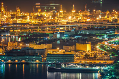 Illuminated buildings in water at night