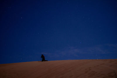 Scenic view of desert against sky at night