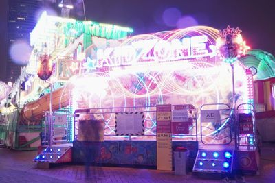 Digital composite image of illuminated ferris wheel at night