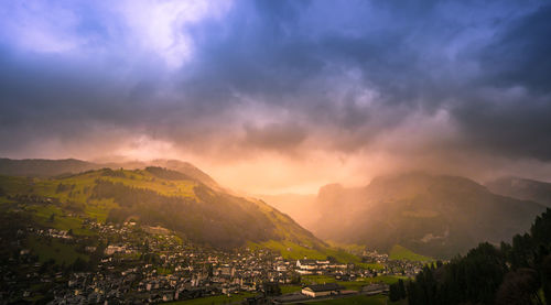 Scenic view of residential district against sky during sunset