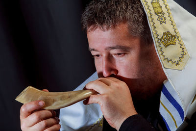 Close-up of man with shofar