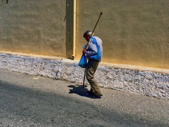 Rear view of a man with umbrella