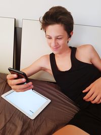 Teenager is using mobile phone at home