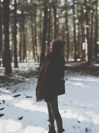 Full length of woman standing on snow covered land