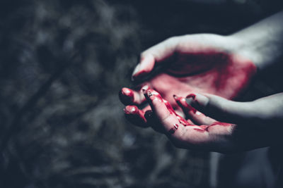 Cropped image of hands bleeding outdoors