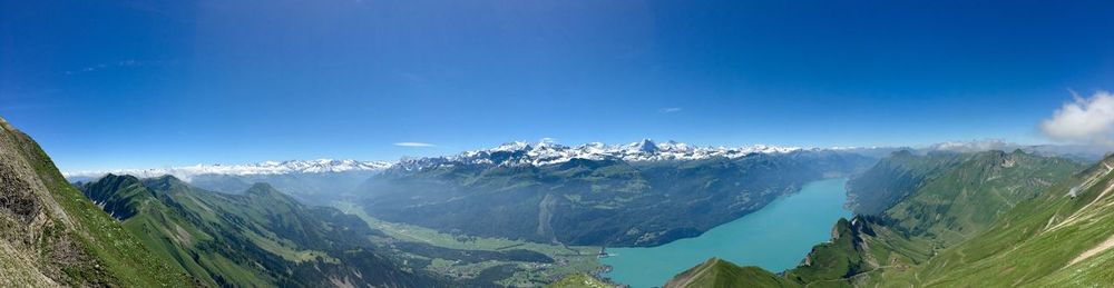 Panoramic view of mountains against blue sky