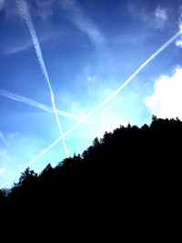 Low angle view of vapor trails in sky