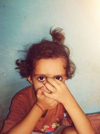 Portrait of cute girl against wall