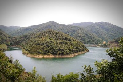 Scenic view of lake and mountains against clear sky