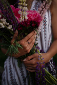 Midsection of woman holding flower bouquet