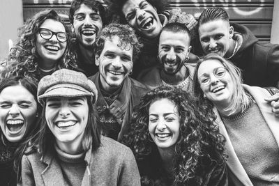 Portrait of smiling young people standing outdoors