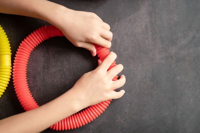 Anti stress sensory pop tube toys in a children's hands. a little kids plays with a poptube toy