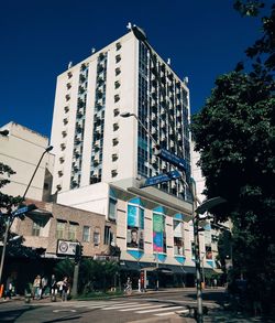 Low angle view of buildings against clear blue sky