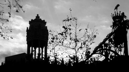 Low angle view of silhouette trees against sky