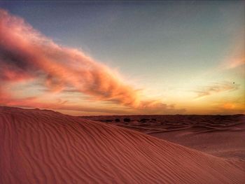 Scenic view of desert against dramatic sky