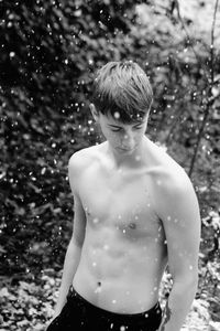 Full length of shirtless boy standing in snow