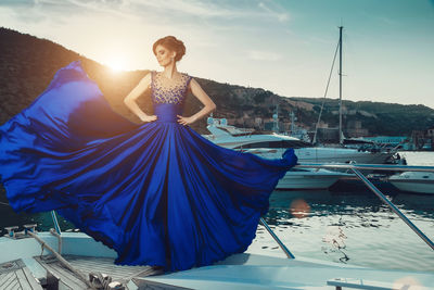 High angle view of woman with umbrella on boat against sky