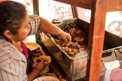 Midsection of woman working in market stall