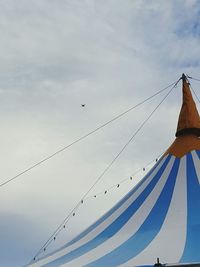 Low angle view of birds flying against sky