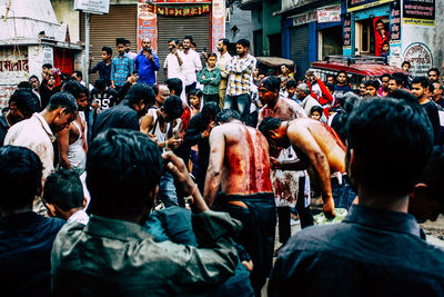 Rear view of people on street in city