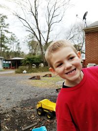 Portrait of smiling boy with horse in background