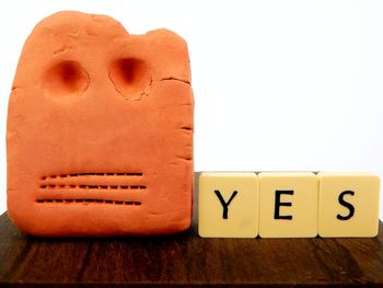 Close-up of information sign on table against white background
