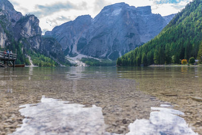 Scenic view of lake and mountains against sky