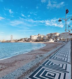 View of sea and buildings against sky