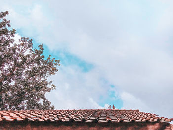 Low angle view of building against cloudy sky