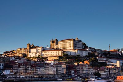 Buildings in city against blue sky