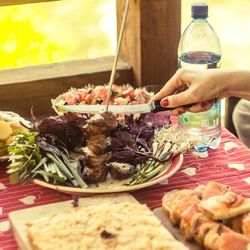 Cropped image of hand holding meat