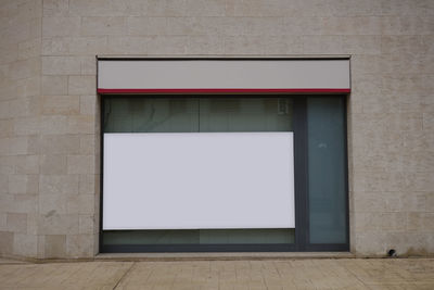 White wall with windows on floor against building